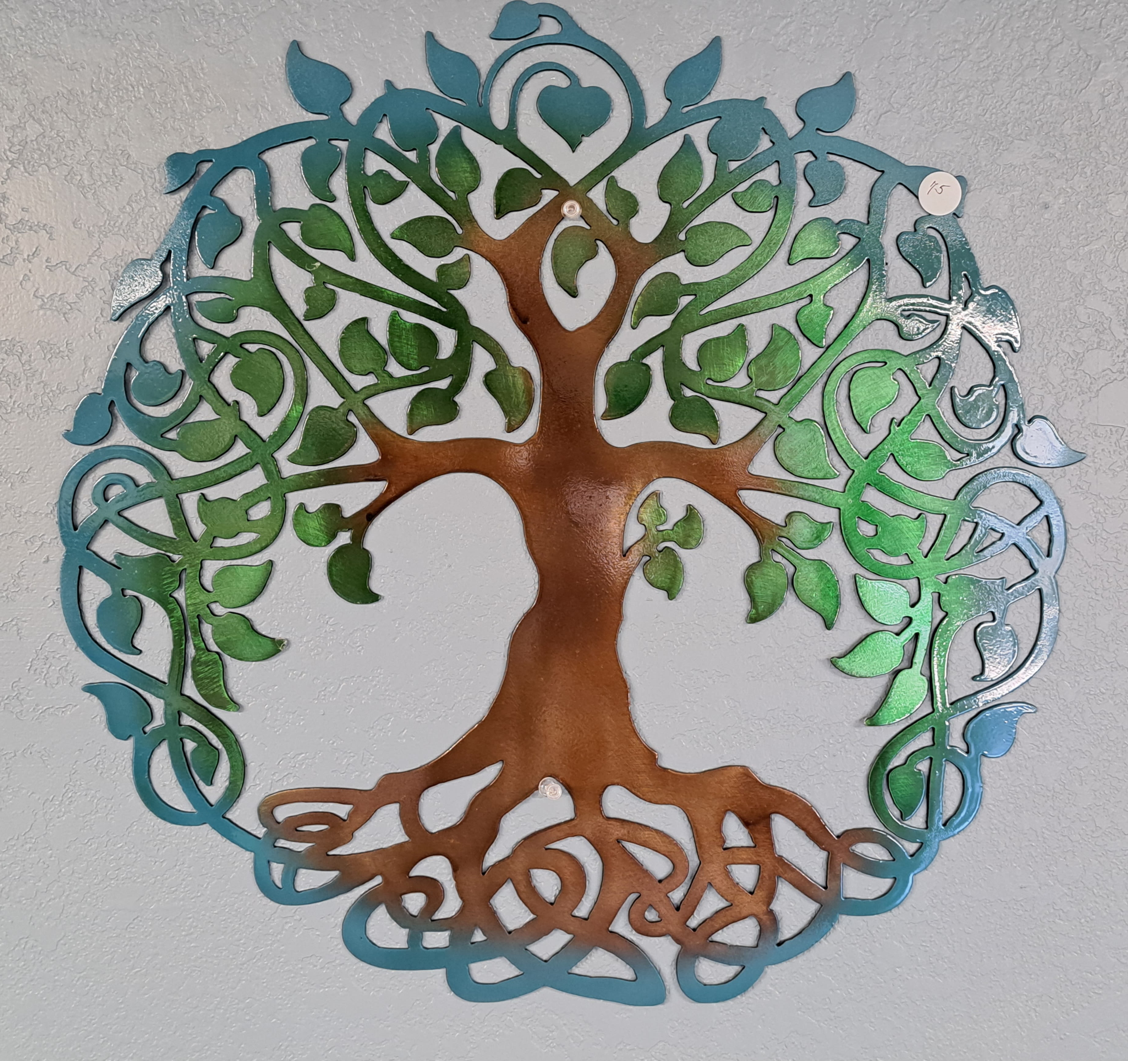 Decorative metal tree wall art with blue and green leaves