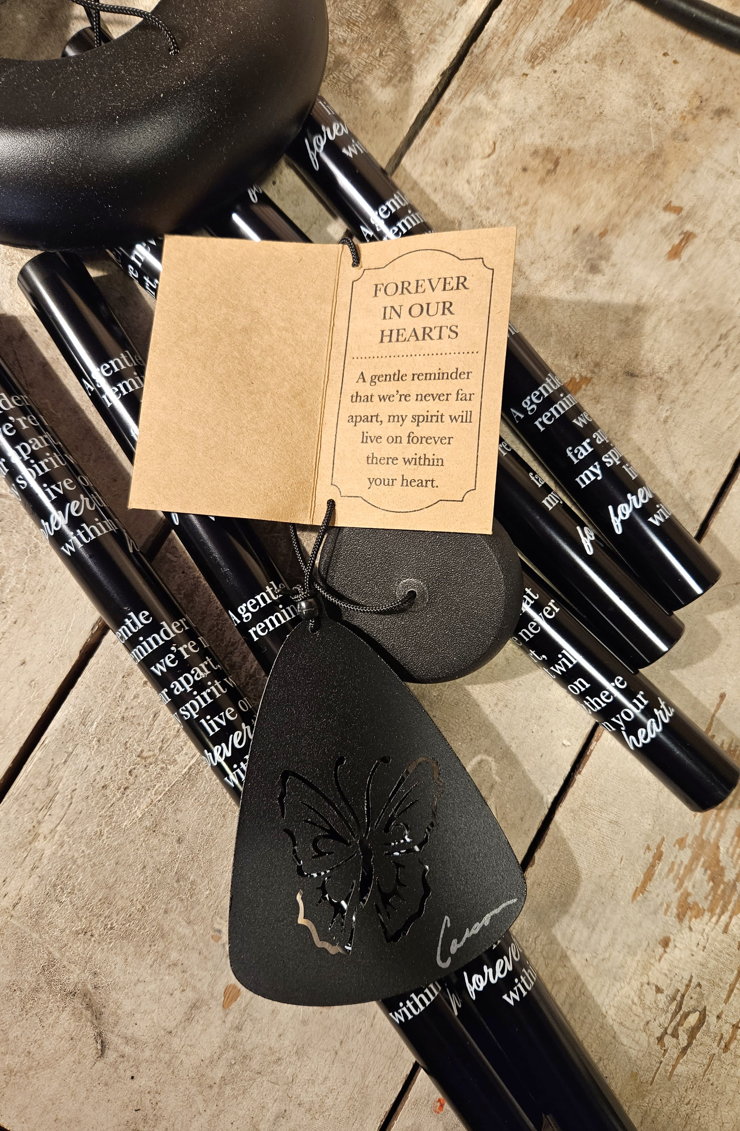 Black memorial candles with a sympathy tag and butterfly ornament
