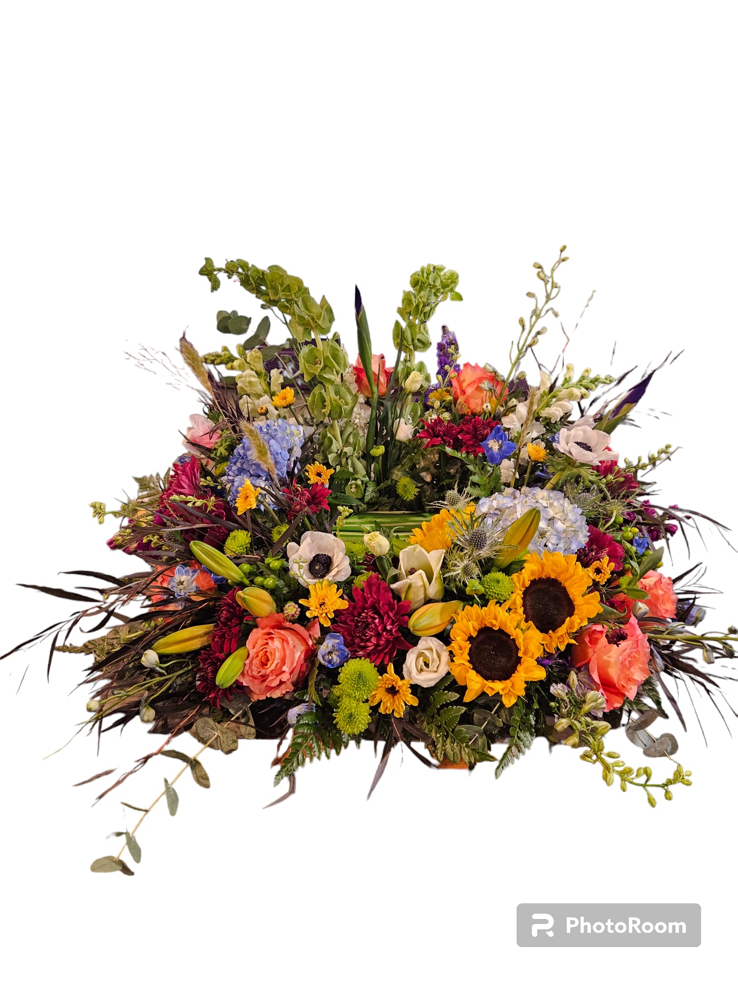 Large mixed flower arrangement with sunflowers, roses, and lilies