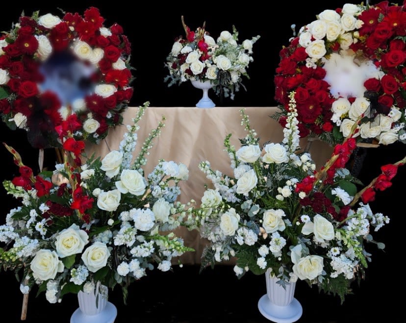 White and red rose funeral wreaths and arrangements on stands