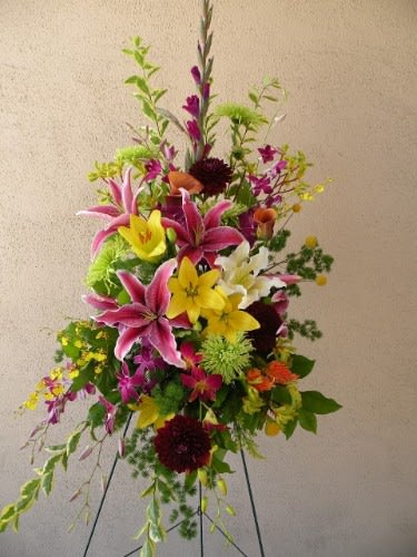 Tall standing floral arrangement with pink and yellow lilies
