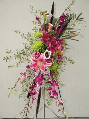 Tall floral arrangement with pink lilies and purple orchids