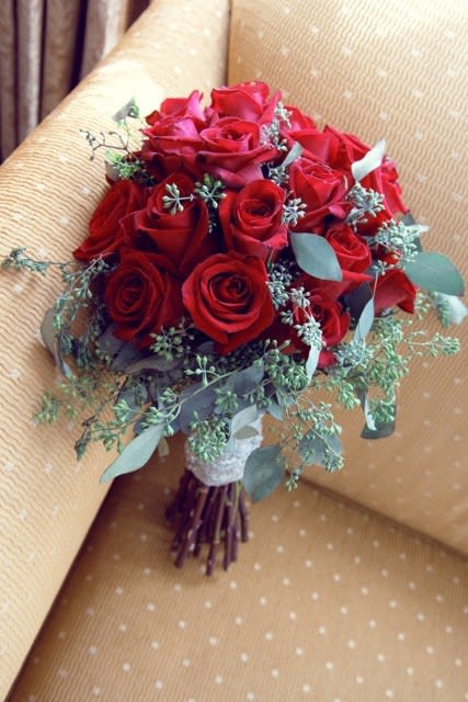 Bouquet of red roses with eucalyptus and small filler flowers