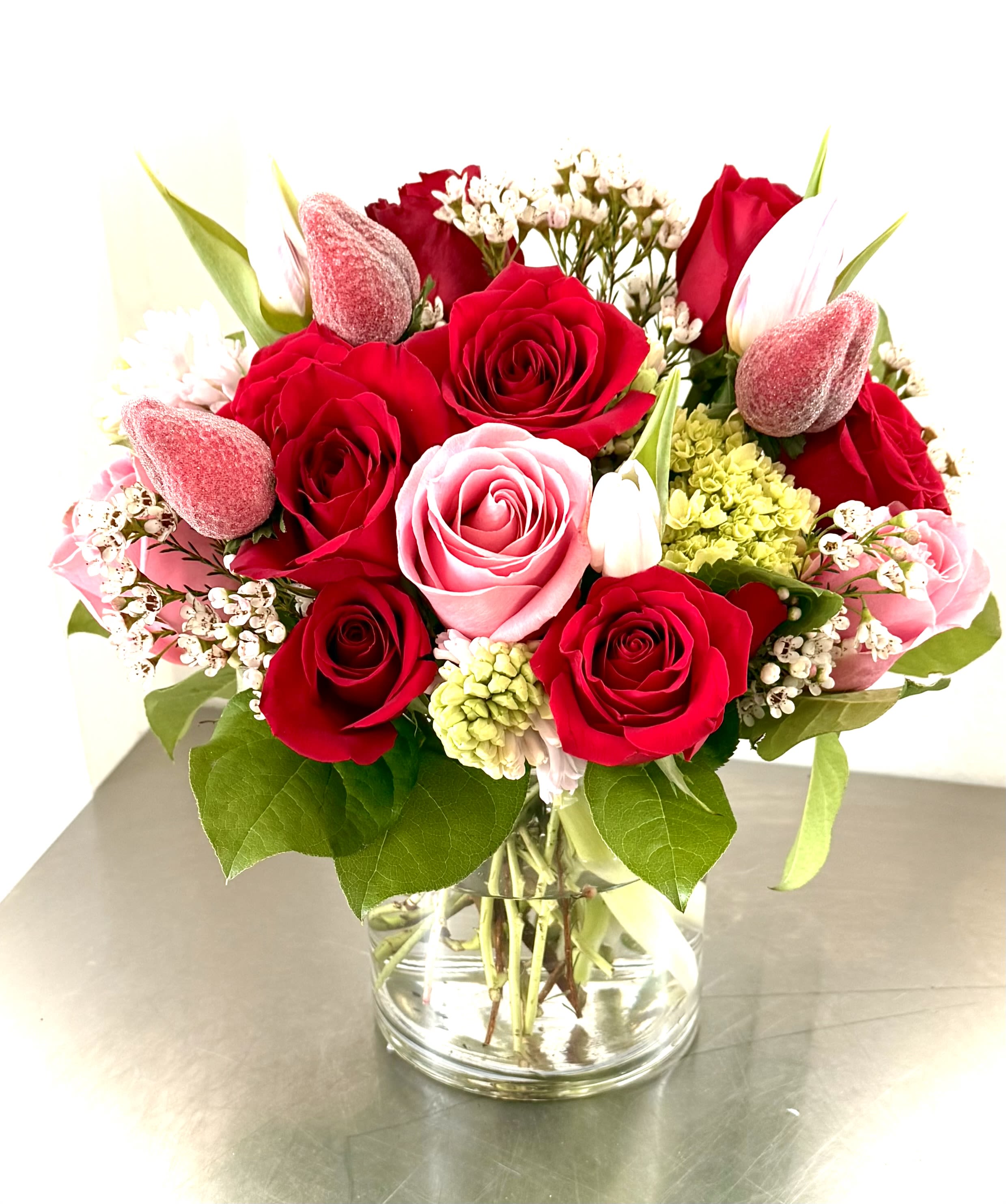 Bouquet of red and pink roses in a clear glass vase