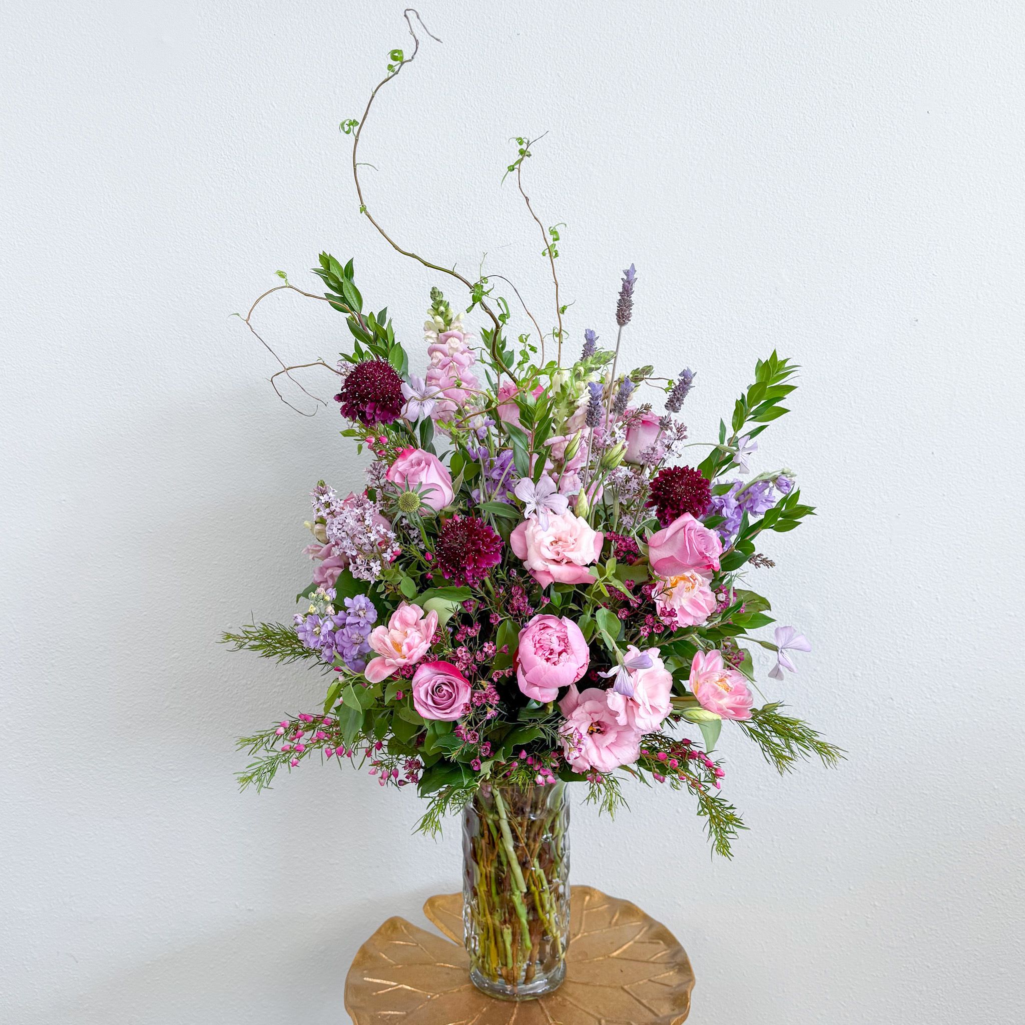 Wild Meadow  - Like a meadow each spring this arrangement will come with fresh surprises. A mix of wild flowers and unique premium blooms; peonies when in season, ranunculus, lavender, boronia...   you never know exactly what you'll get but we will create a bouquet that feels like a luxury tour through the flower fields in a range of pinks and lavenders. Soft and fragrant, this is a memorable expression of your feelings. 