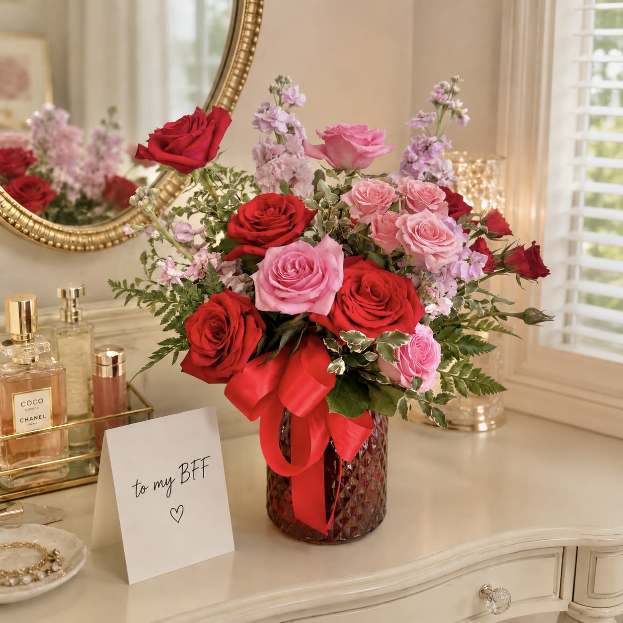 Sweetness - A lush cluster of red and pink roses layered with pale pink stock  sends sweet sentiments. Ideal for a new romance, or to make a good friend smile. The rounded, garden-style composition reads intimate and cheerful at once; a gesture that says "I'm thinking of you" or "I'm sorry" without being overly formal.   This is the kind of bouquet that will make the person you're thinking of feel truly seen - whether celebrating love, mending a moment, or brightening an ordinary day. Designed to arrive gift-ready, it needs only fresh water; replace the water every other day and recut stems if you want to extend vase life.