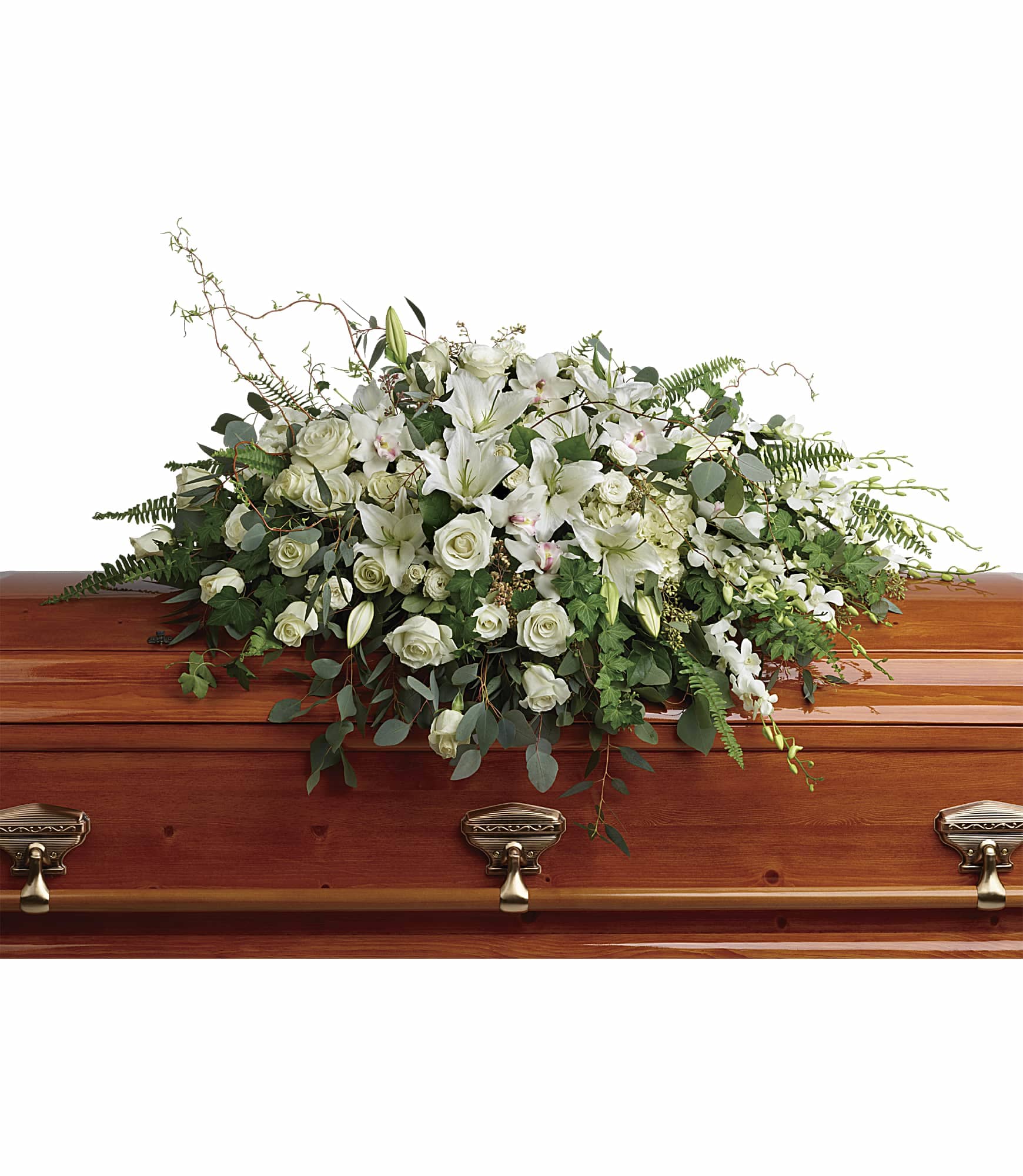White casket spray of lilies, roses, and orchids on a polished wood casket
