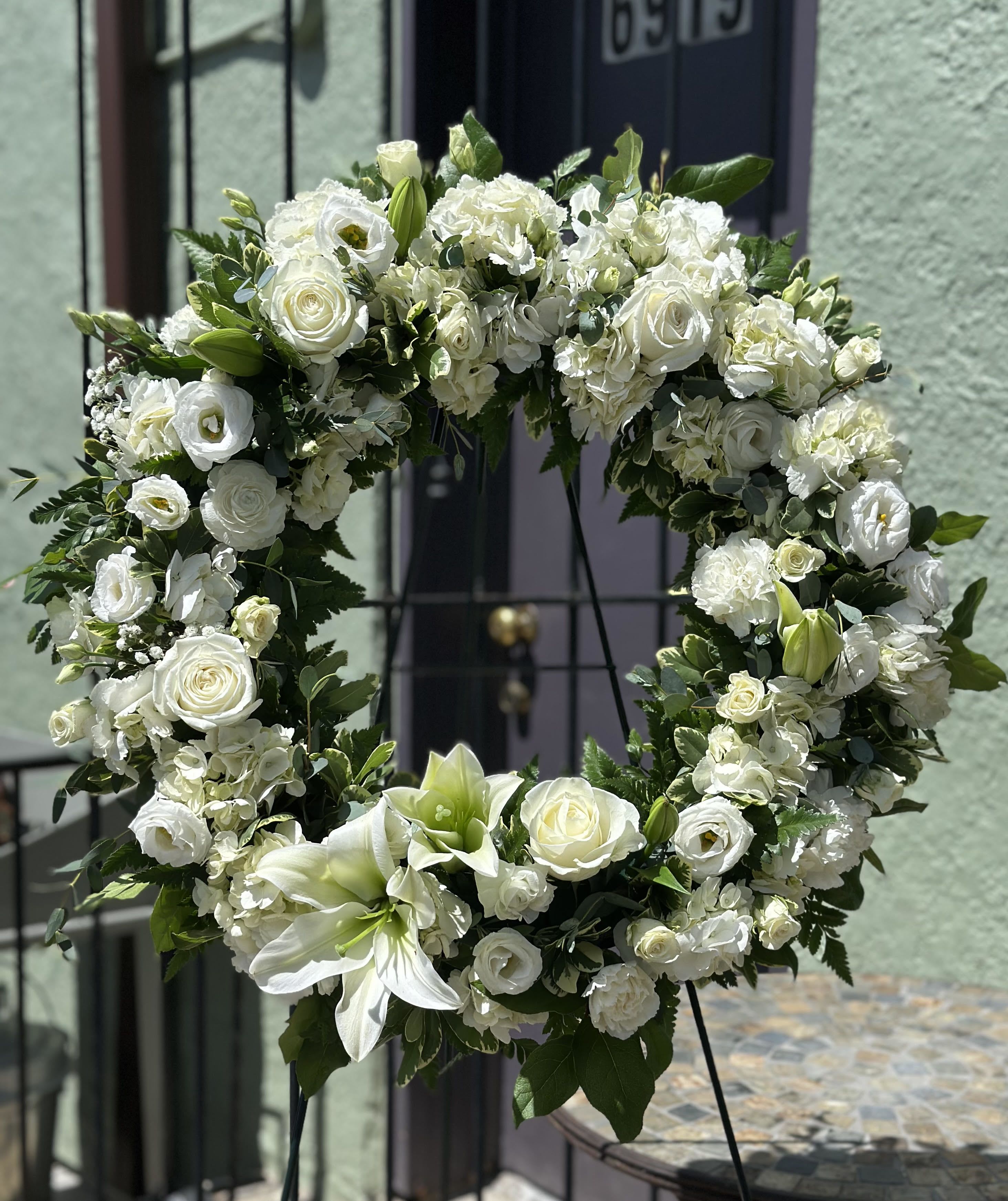 Serenity Wreath - A ring of fragrant, bright white blossoms will create a serene display at any funeral or wake. This classic wreath is delivered on an easel, and is a thoughtful expression of sympathy and admiration. 