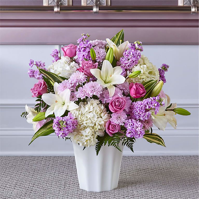 Pink and white flower arrangement in a white vase