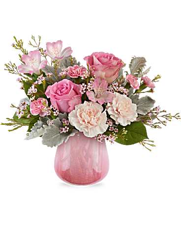 Pink roses and carnations in a pink glass vase