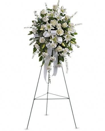 White floral standing spray on an easel with ribbon