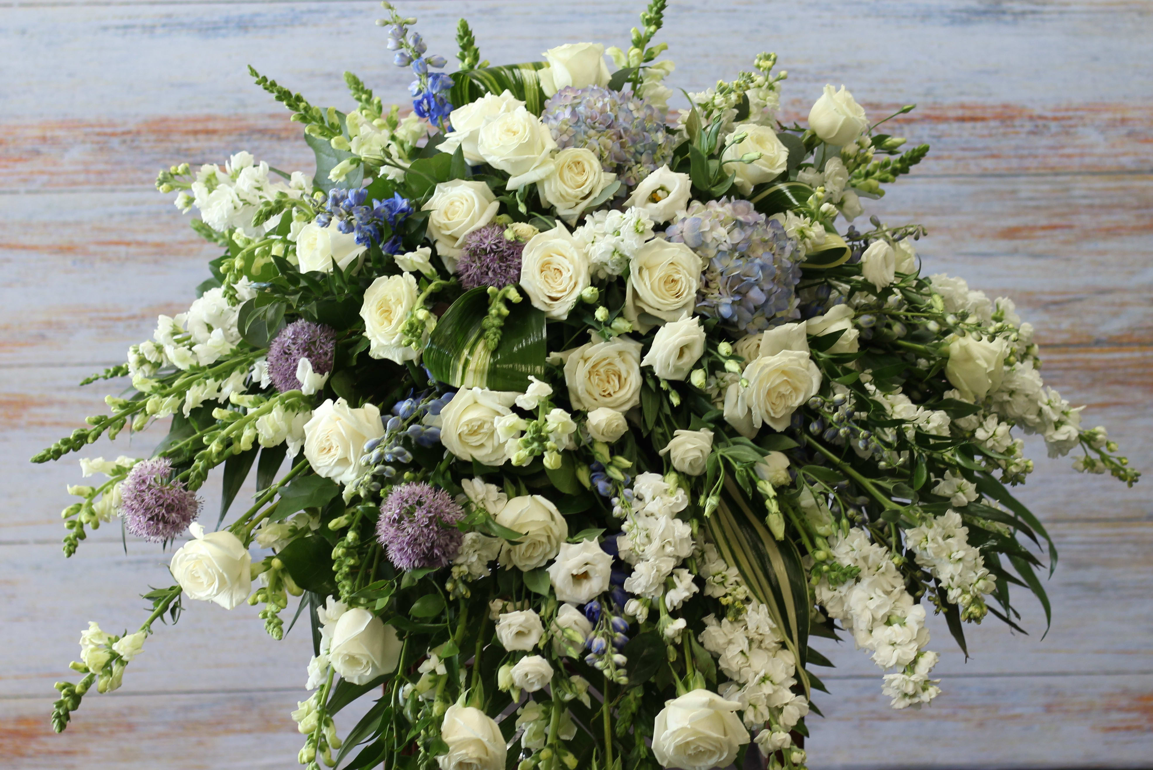 Large white floral spray with roses and lavender accents