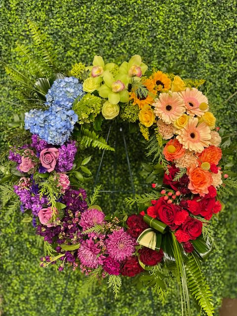 Rainbow floral wreath with roses, hydrangeas, and gerbera daisies