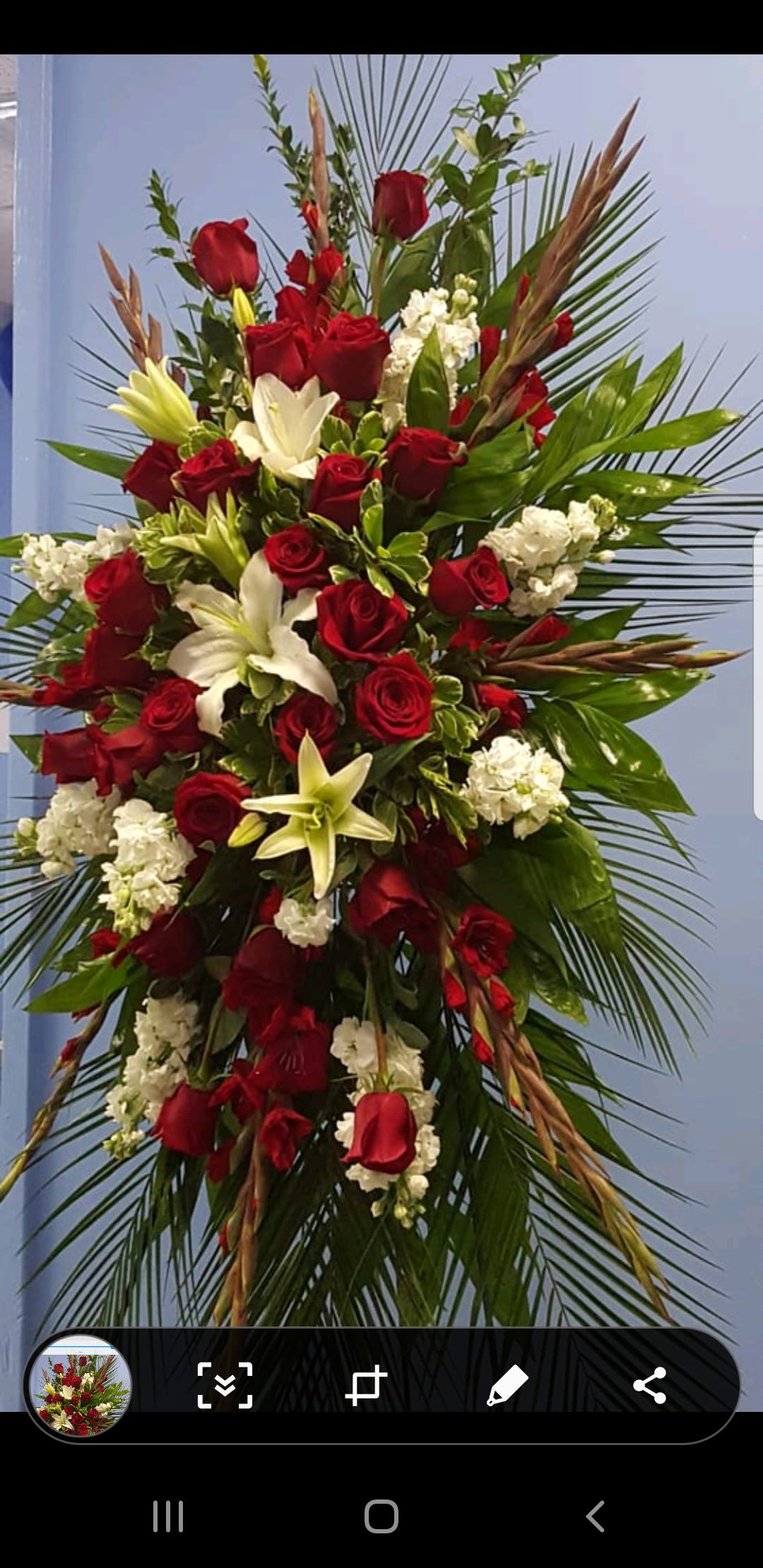 Tall red and white floral spray with palm fronds