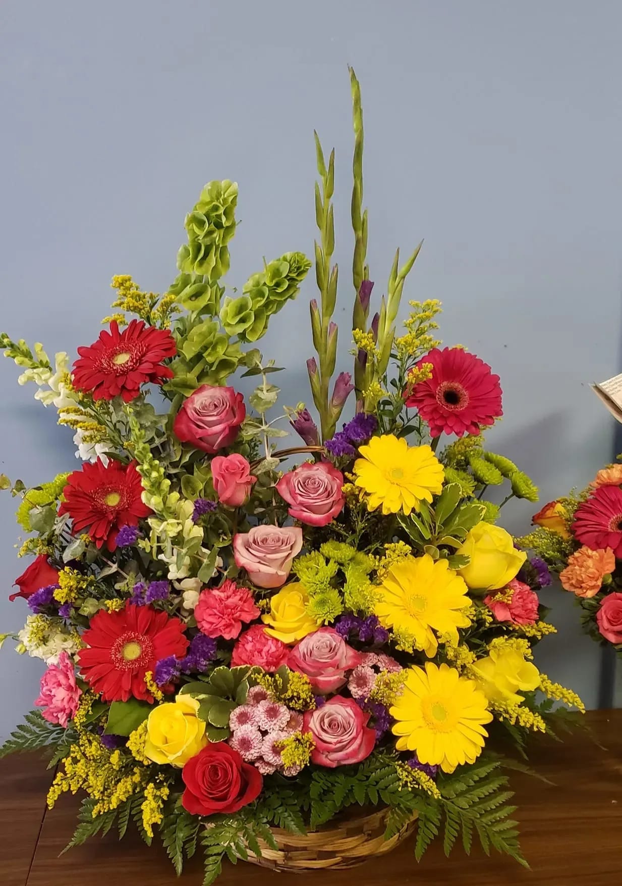 Colorful mixed flower arrangement in a wicker basket