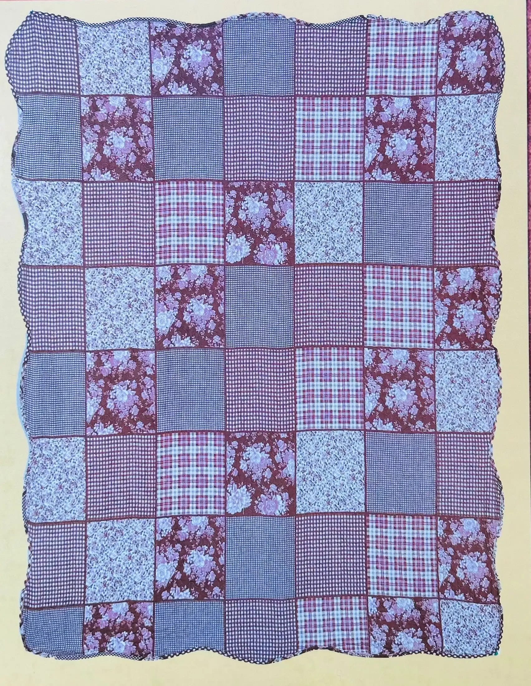 Patchwork quilt with red, blue, and floral fabric squares