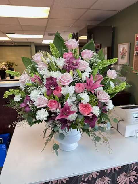 Compassionate Love - Pink, green and white arrangement to be displayed at the service. 
