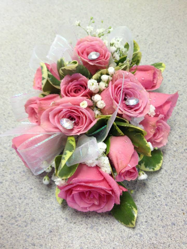 Pink rose bouquet with white filler flowers and ribbon accents