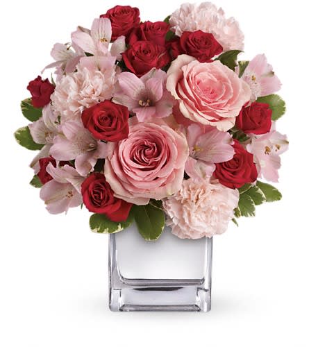 Teleflora's Love That Pink Bouquet with Roses - Passionately pretty in pink this gorgeous array of pink and red roses and other favorites in a chic mirrored silver cube is a guaranteed heart-winner. She'll be thrilled with the gift and knocked out by your impeccable taste. This exquisite bouquet includes pink roses red spray roses pink alstroemeria and pink carnations accented with assorted greenery. Delivered in a mirrored silver cube. Approximately 11" W x 12 1/2" H Orientation: One-Sided As Shown : T409-3A Deluxe : T409-3B Premium : T409-3C