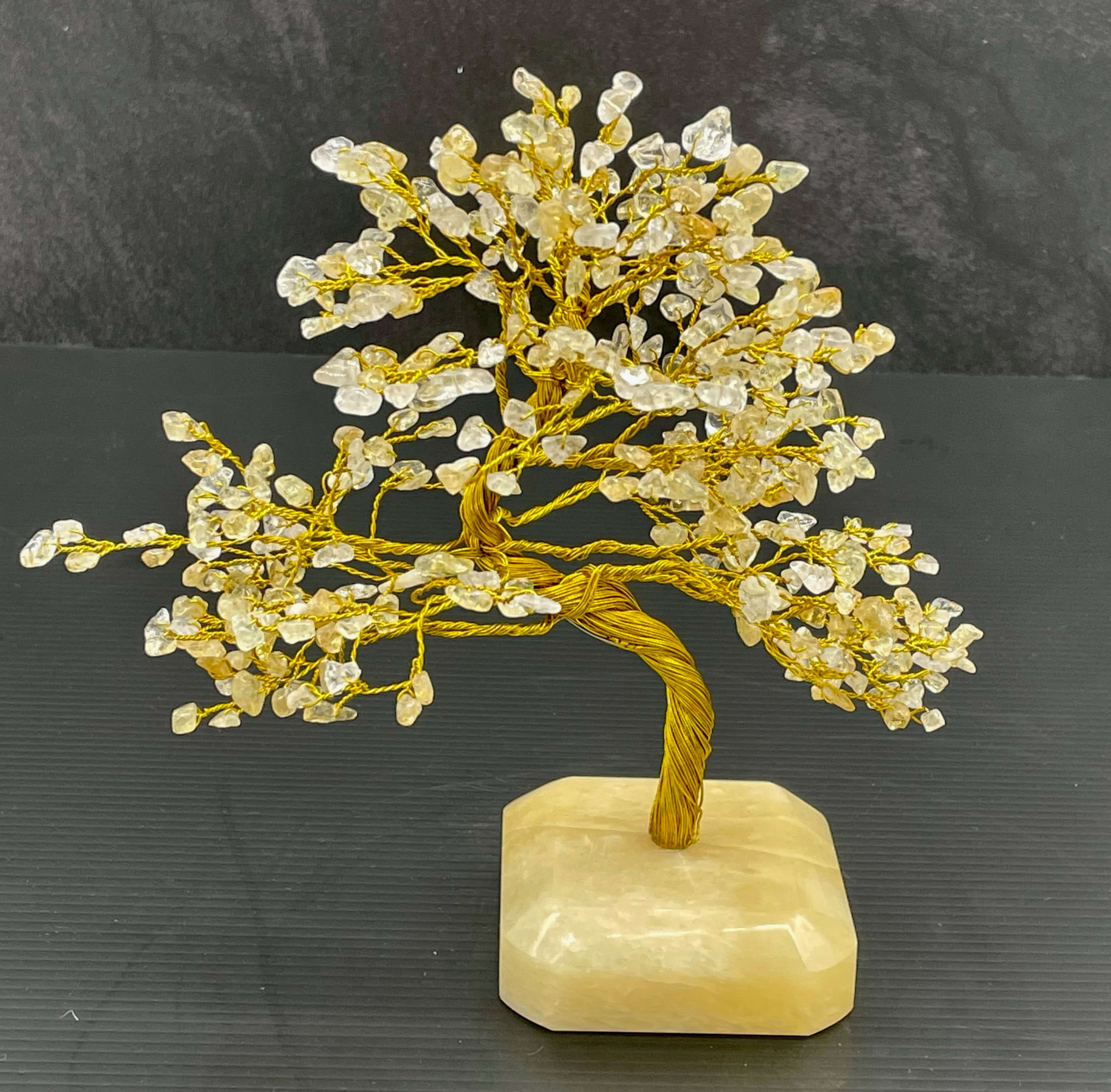 Decorative crystal tree sculpture on a stone base