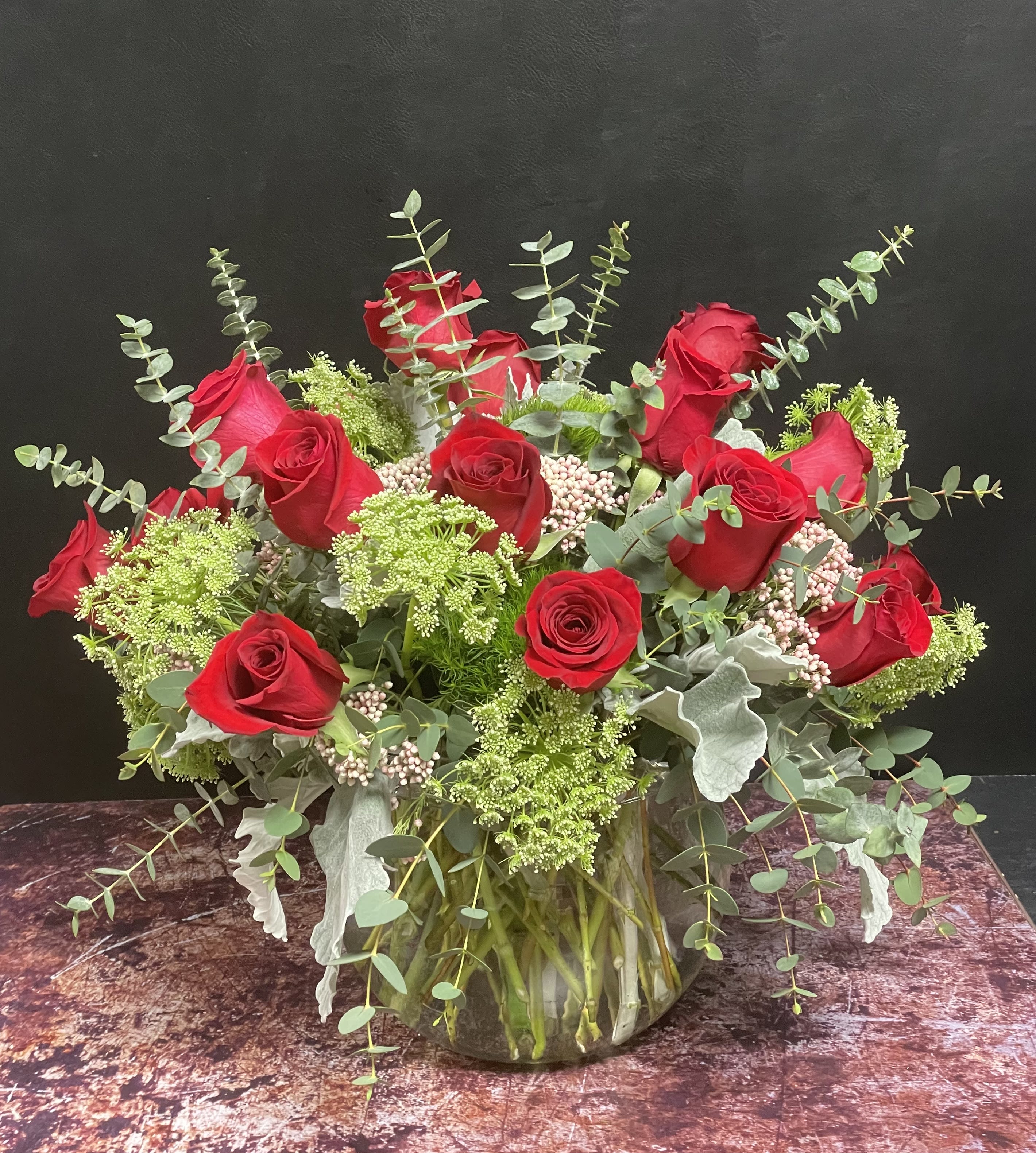 Forever yours - 18 red roses, green dianthus, dusty miller, rice flowers, queen anne's lace, and eucalyptus.