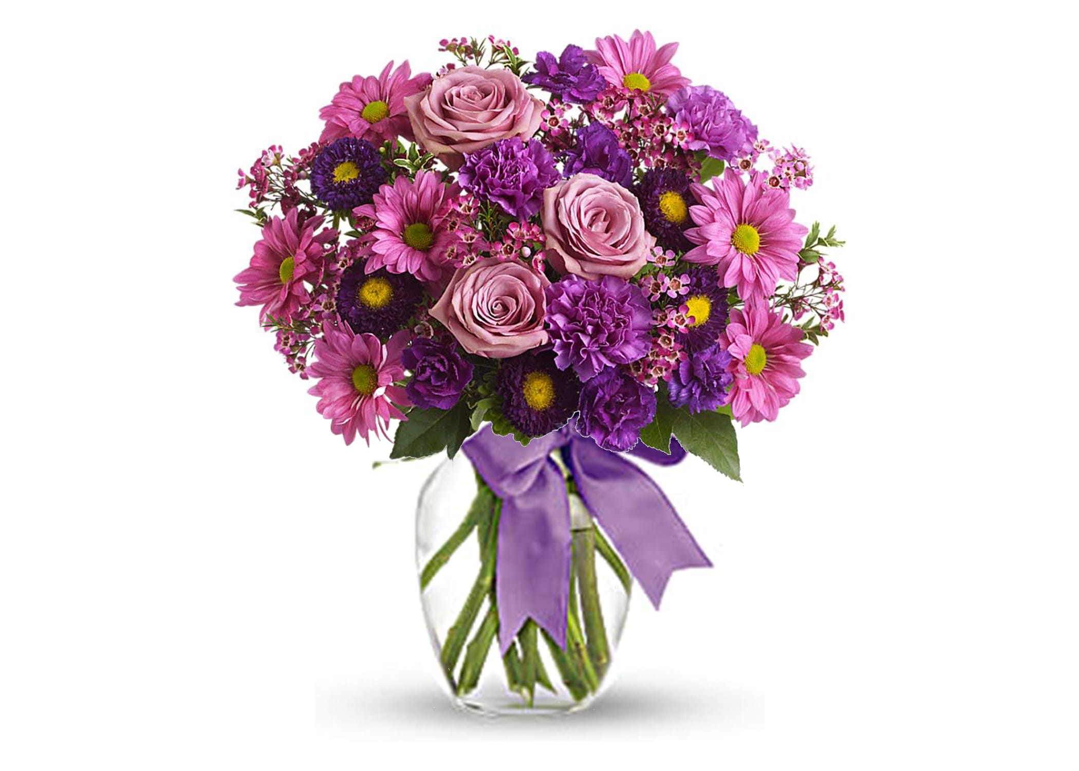 Mixed bouquet of purple and pink flowers with roses in a clear vase tied with a purple ribbon