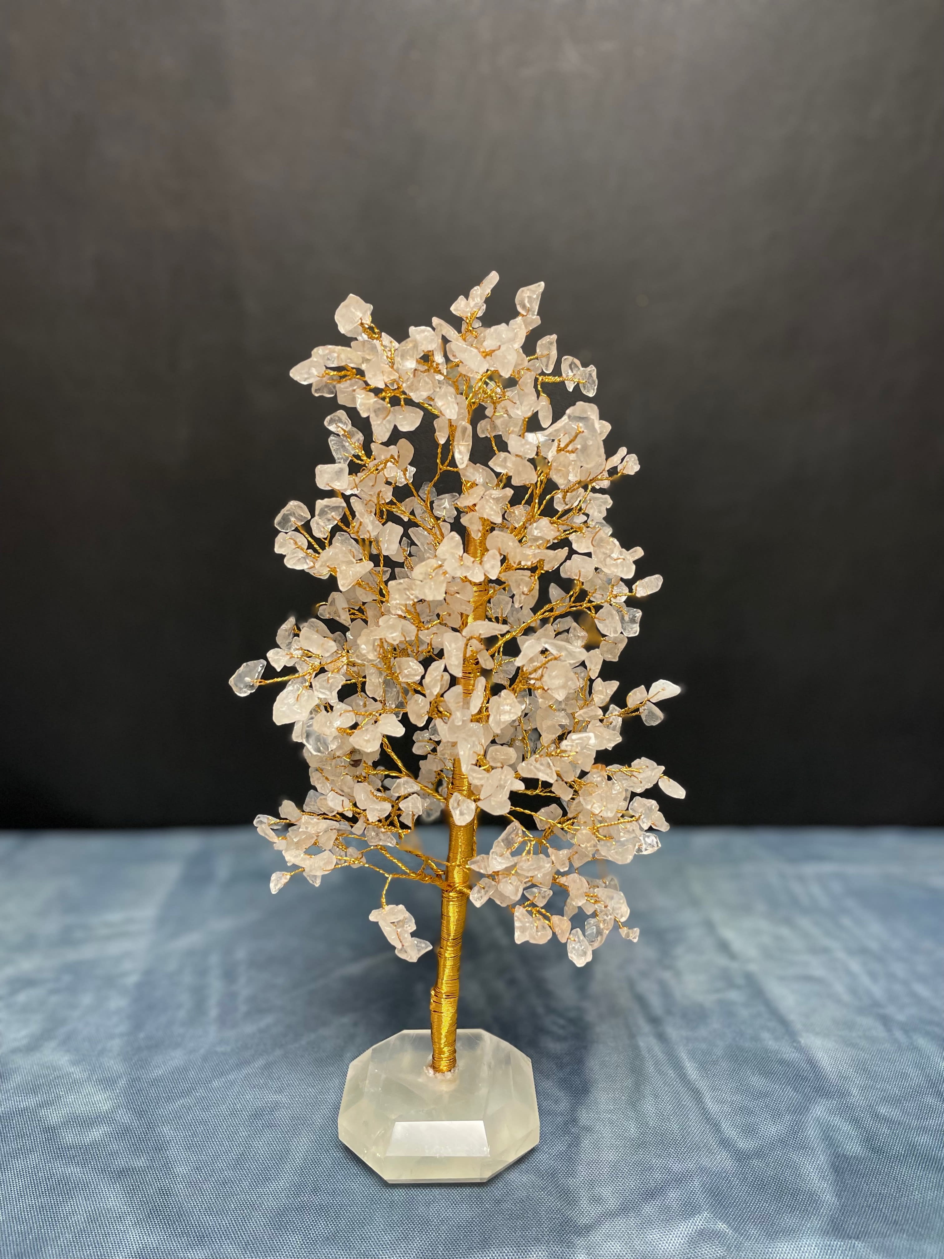 Wire gemstone tree with clear crystal chips on a faceted stone base