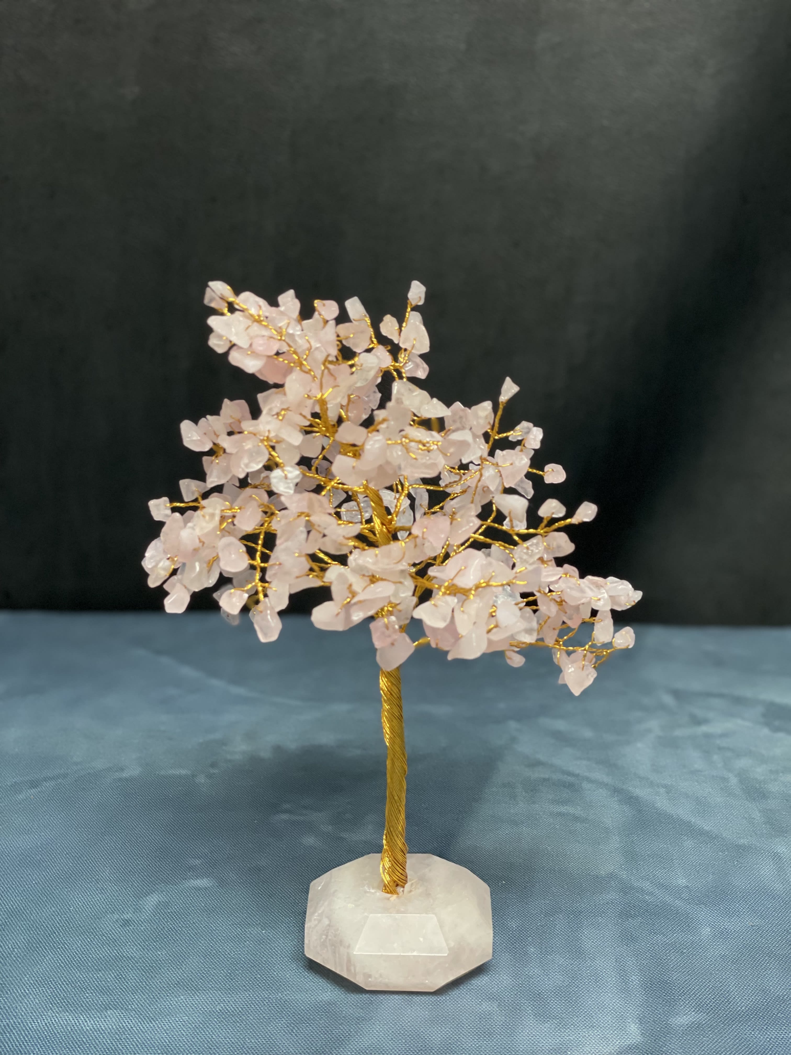 Small crystal tree with pale pink stones on a white base