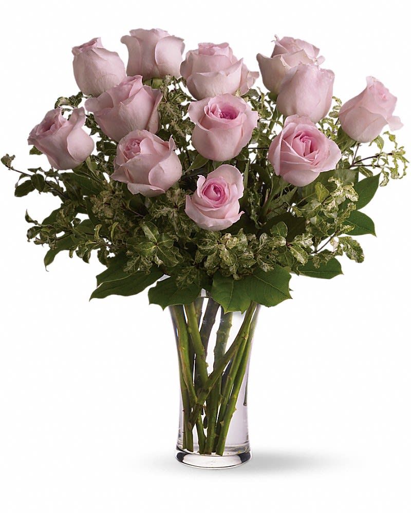 A Dozen Pink Roses - Pretty, pink and perfect. There's nothing like long-stemmed pink roses to show your affection. A dozen pink roses with variegated pittosporum and salal in a beautiful glass vase.