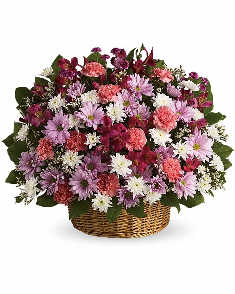 Basket arrangement of pink carnations, purple and white daisies, and dark pink blooms