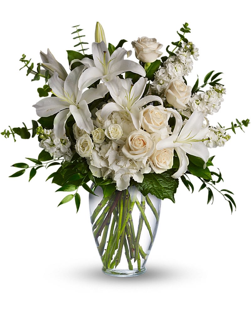 Dreams From the Heart Bouquet - A lovely bouquet to soothe and comfort, a variety of white and peach blossoms sends your hope and strength. Beautifully. Beautiful flowers such as white hydrangea, spray roses and stock, white roses, eucalyptus and more fill a tall glass vase.