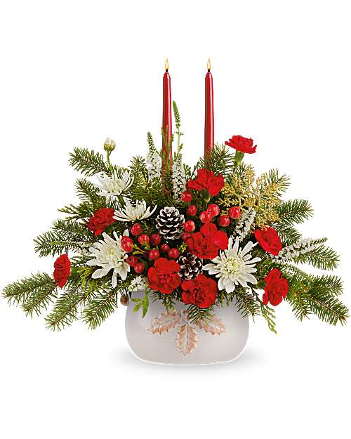 Teleflora's Happy Holly Centerpiece - Teleflora's Happy Holly Centerpiece is brimming with holiday cheer! Festive blooms and winter greens are hand-arranged with bright berries and natural accents, topped with two red candles in Teleflora's Holly Season Bowl. A festive Christmas centerpiece for gatherings all season.
