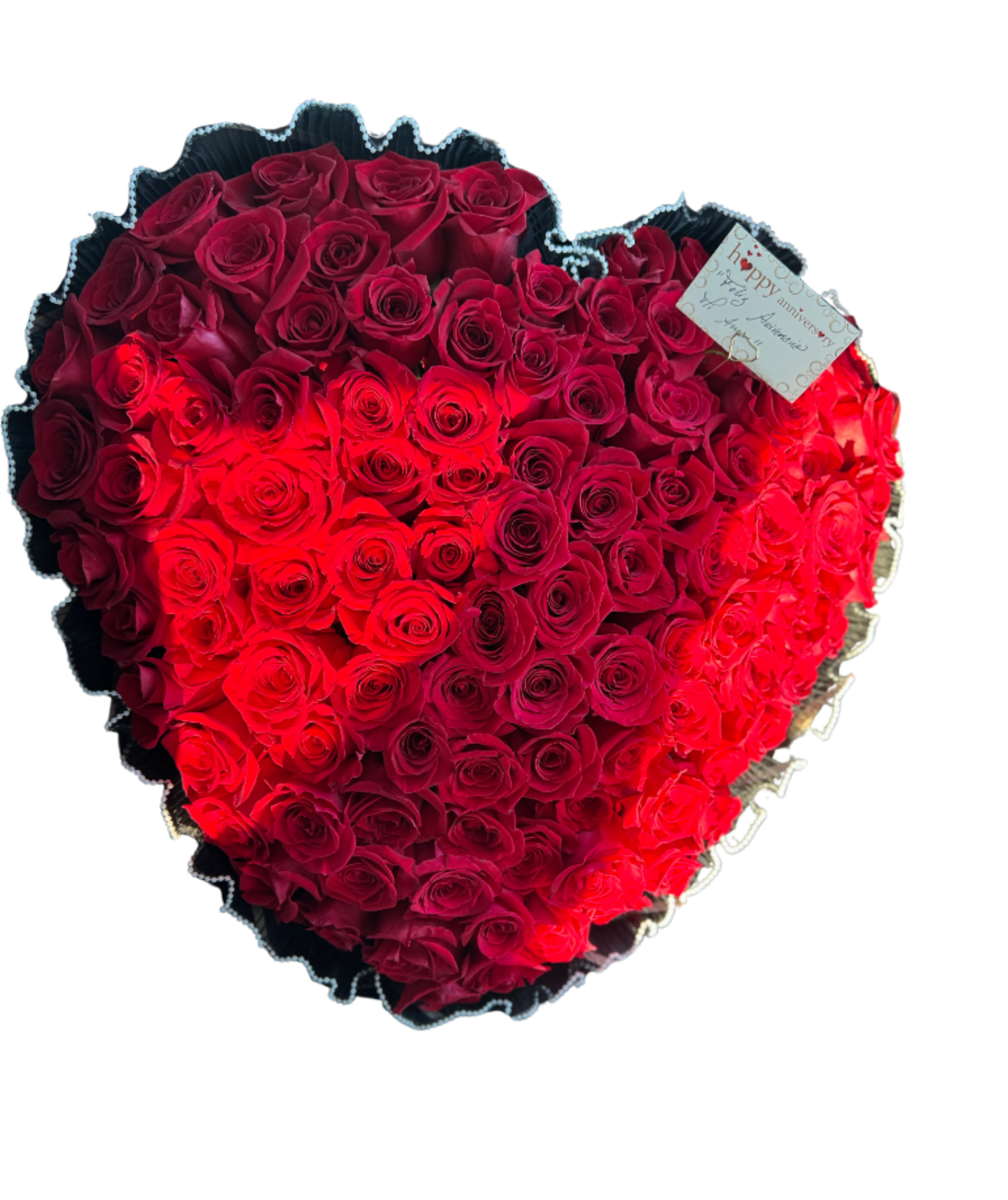 Big Heart Bouquet - A lush heart-shaped bouquet of tightly packed red roses to make an unmistakable romantic statement - perfect as an anniversary bouquet or a grand Valentine's Day gift. The dome-like heart reads luxurious and dramatic: deep crimson blooms sit beside brighter red petals so the arrangement catches light and feels alive, while a tucked anniversary card quietly carries your message to the person you're celebrating.  These are premium red roses arranged in a large, dense heart and framed in dark decorative wrap that intensifies the color and gives a modern, elegant contrast. The package includes a small gift tag and decorative wrapping; the bouquet's rounded silhouette is designed to read full and abundant from every angle, creating an instant focal point in any room.  Give this when you want her to feel truly cherished - the kind of arrangement that says devotion and celebration at once. Order with your message on the included anniversary card and choose delivery timing to ensure the roses arrive fresh and ready to impress.