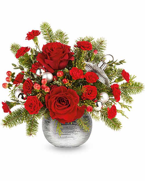 Teleflora's Silver Sparkle Bouquet - Teleflora's Silver Sparkle Bouquet shines with bold holiday style! Red roses and carnations are hand-arranged with winter greens and festive accents in Teleflora's Silver Sparkle Ornament. This Christmas arrangement adds a bright, polished touch to seasonal décor.