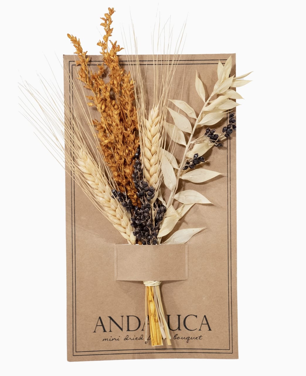 Dried bouquet of wheat and seed stems on a kraft paper card