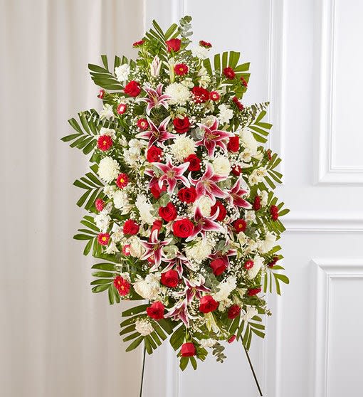 Standing floral spray with red and white flowers on an easel