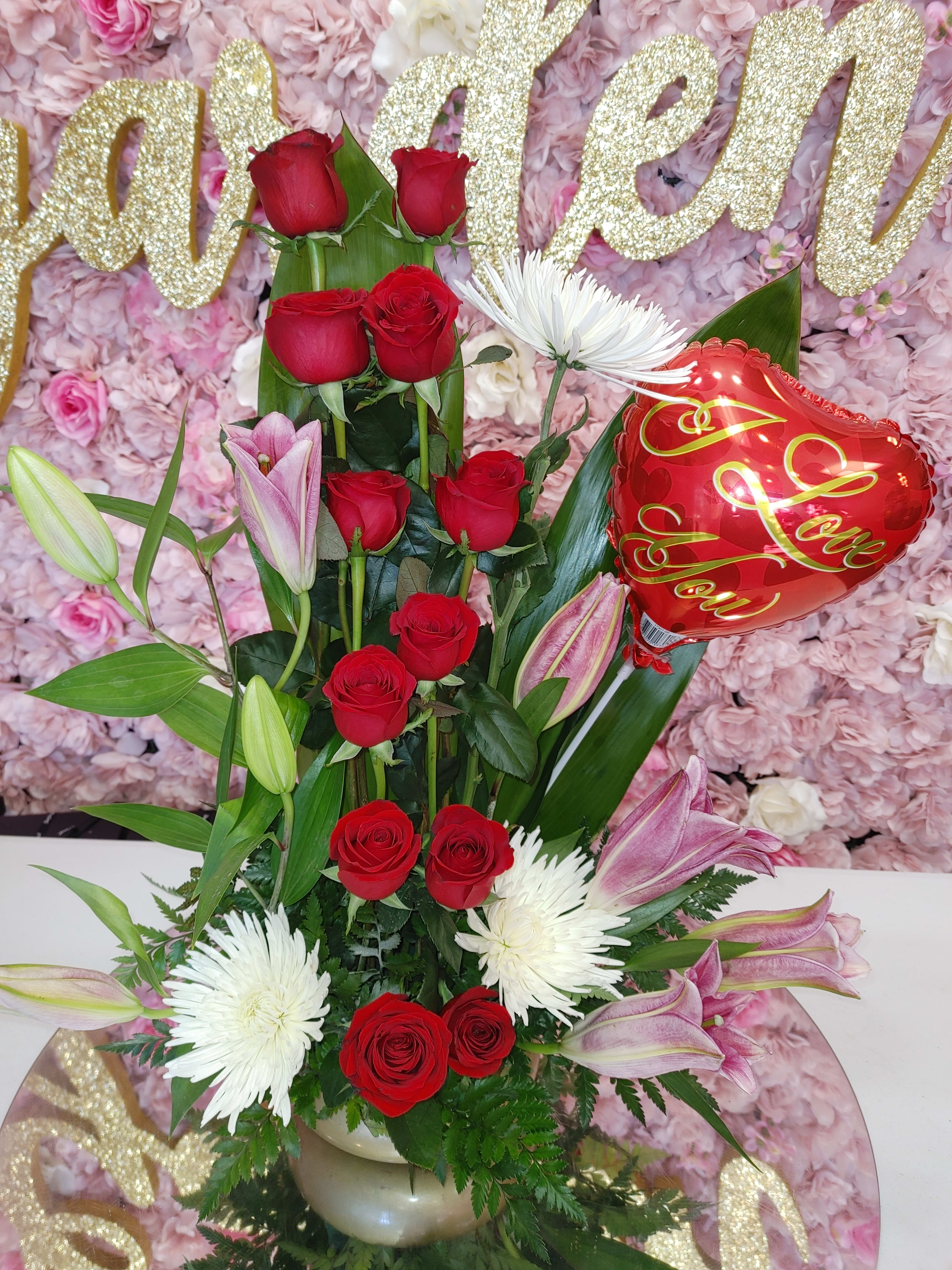 Tall bouquet of red roses, white spider mums, pink lilies, and a heart balloon