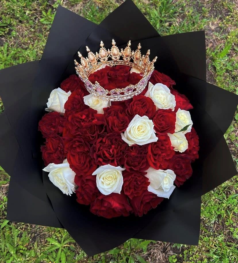 Bouquet of red and white roses with a jeweled crown on top