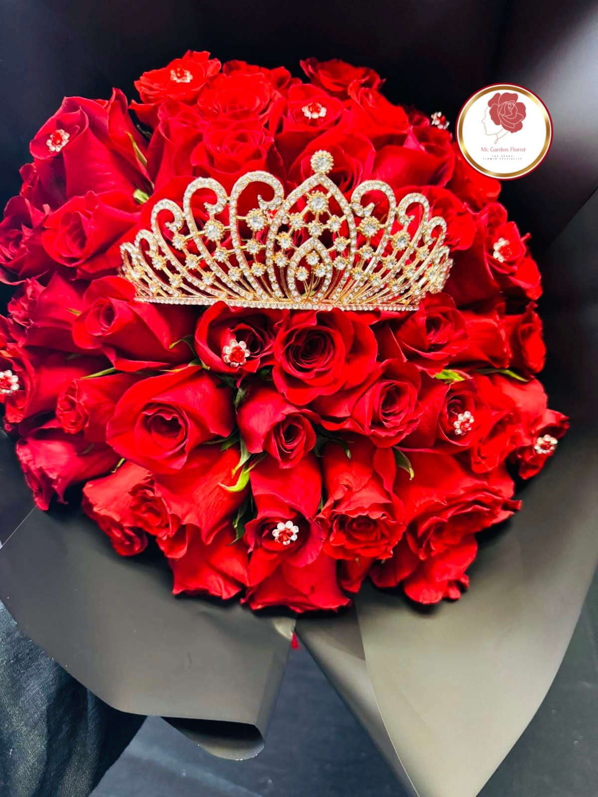 Bouquet of red roses with a jeweled tiara on top