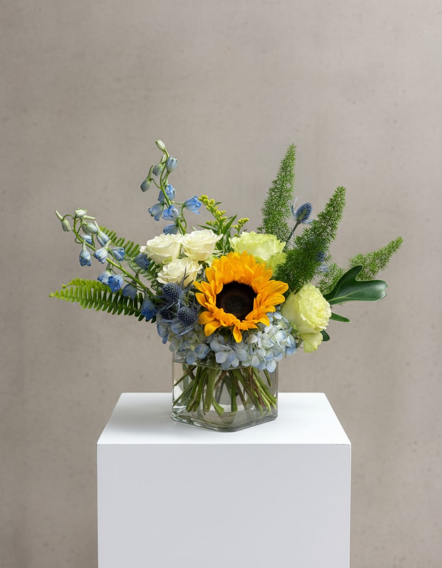 Mixed bouquet with a sunflower in a glass vase