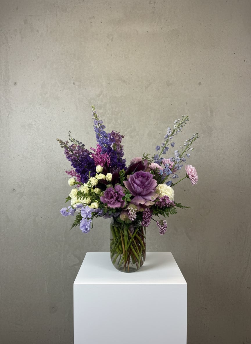 Purple and lavender bouquet in a clear glass vase