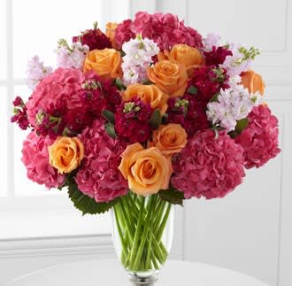Astonishing Luxury Mixed Bouquet - Blossoming with the color and grace that can only be supplied through the soft beauty of roses, hydrangea and fragrant stock, this bountiful flower bouquet will amaze your special recipient. Brilliant orange roses display their swirling petals amongst clouds of pink hydrangea and pale pink and hot pink stock stems to create a fantastic look.   IMPORTANT NOTE: This vase has been discontinued so we will have to substitute another vase for what you see pictured.