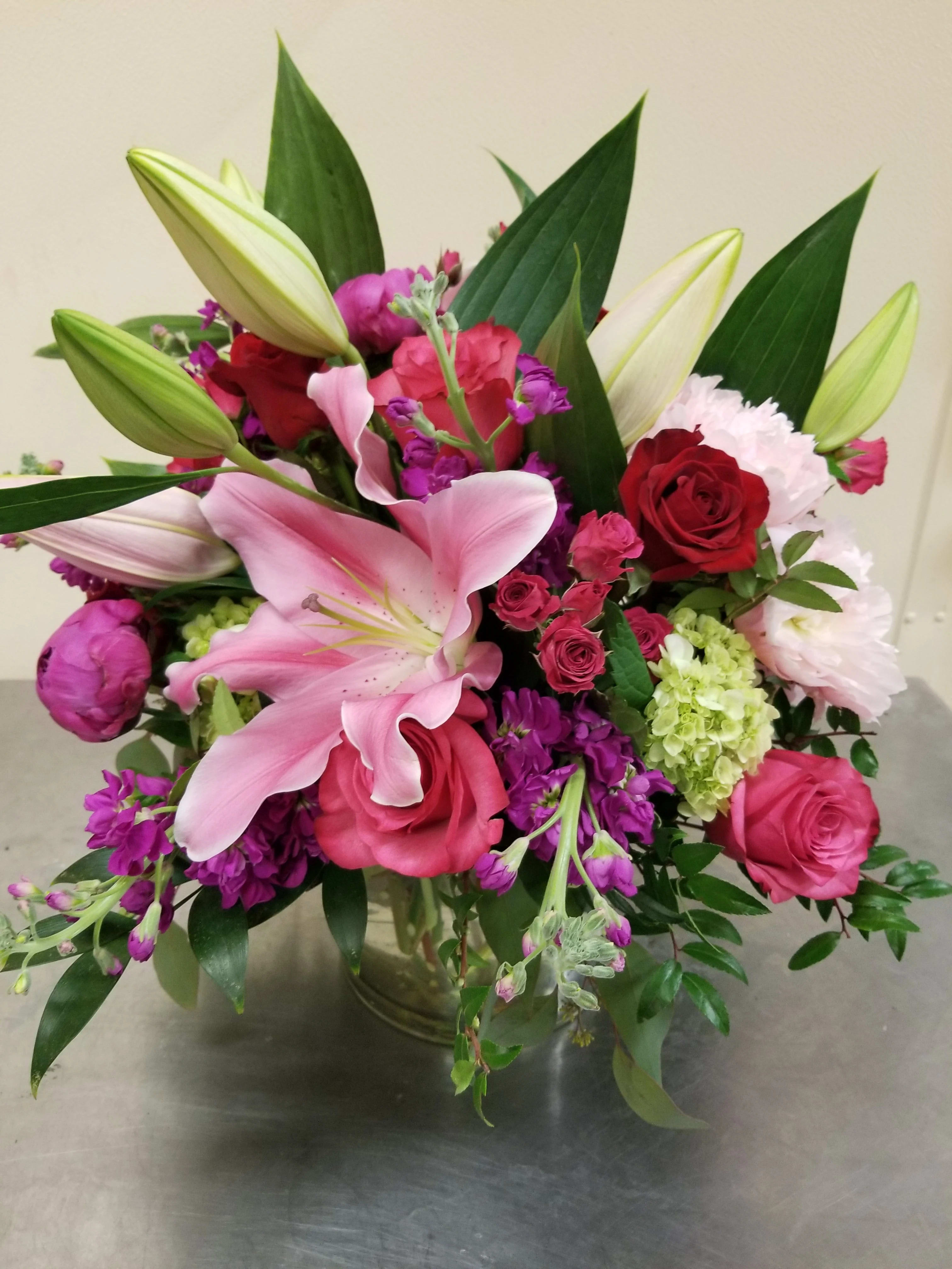 "Love's True Voice" Bouquet - This premium assortment of blooms will certainly get attention! Large Oriental lilies, peonies, red and pink roses all combine to create a truly remarkable bouquet. 