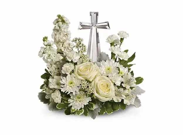 White floral arrangement with a silver cross centerpiece