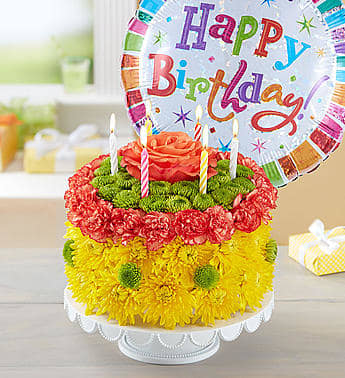 Flower cake with candles and a birthday balloon