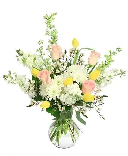 Bouquet of pink roses, white daisies, and yellow tulips in a glass vase