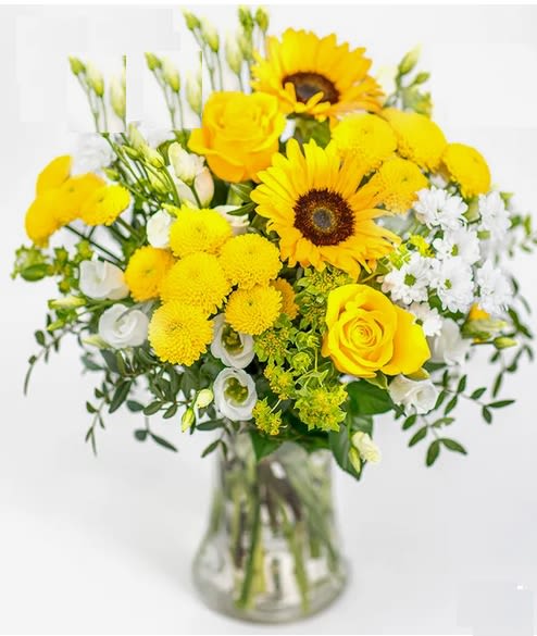 Yellow and white mixed bouquet in a clear glass vase