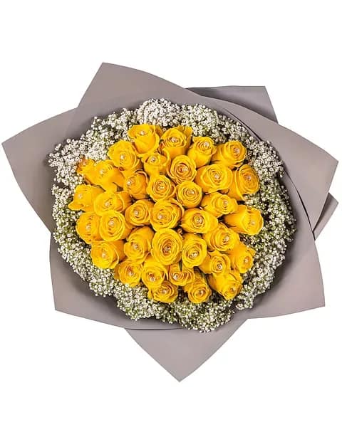 Luminous Yellow Roses wrapped Bouquet - This cheerful bouquet of 36 yellow roses, beautifully Wrapped with elegant brown ribbons, is a vibrant expression of joy, friendship, and warmth. Perfect for birthdays, congratulations, or heartfelt gestures,  promotions, graduation this arrangement radiates positivity and charm.  