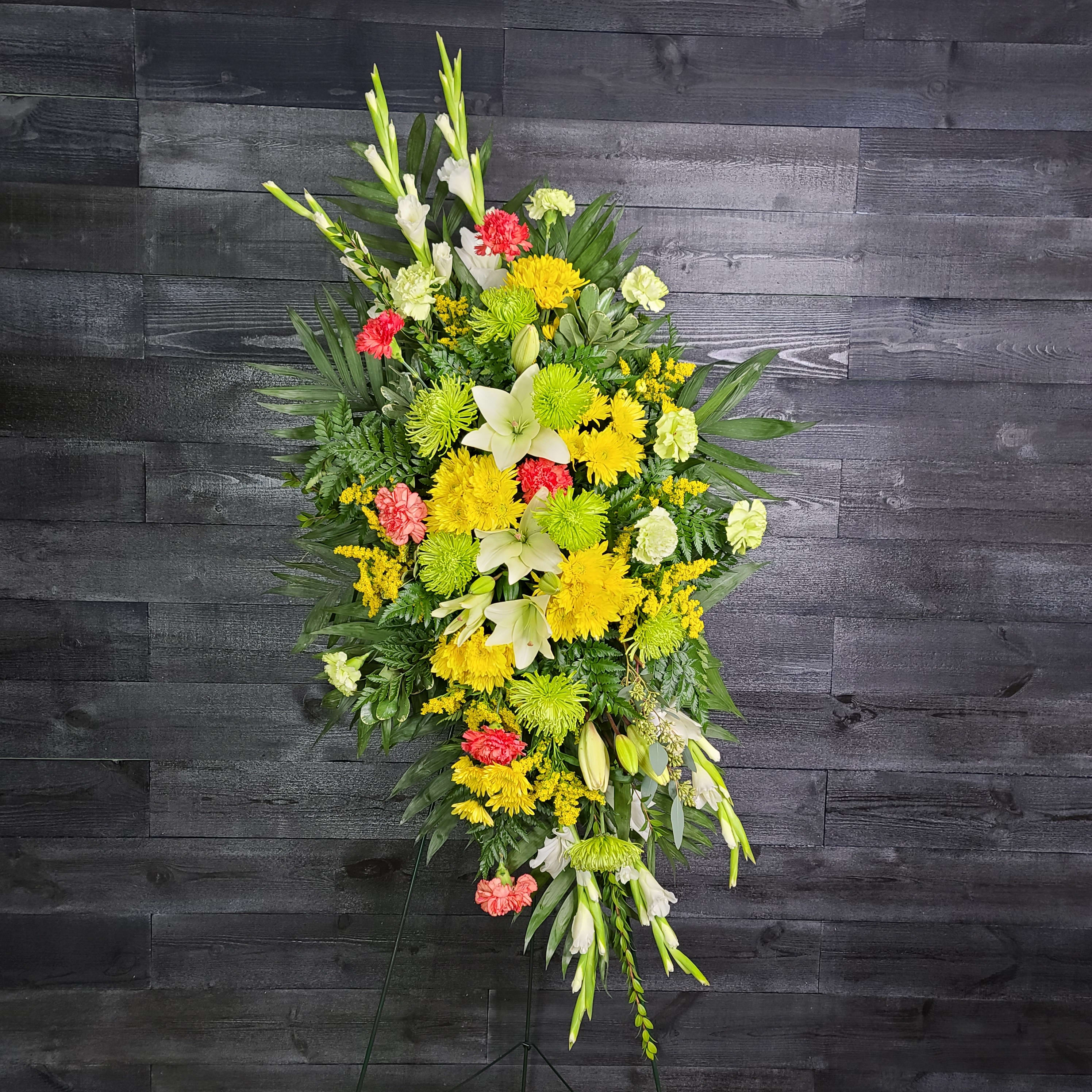 Tall standing floral spray with yellow, white, and coral flowers