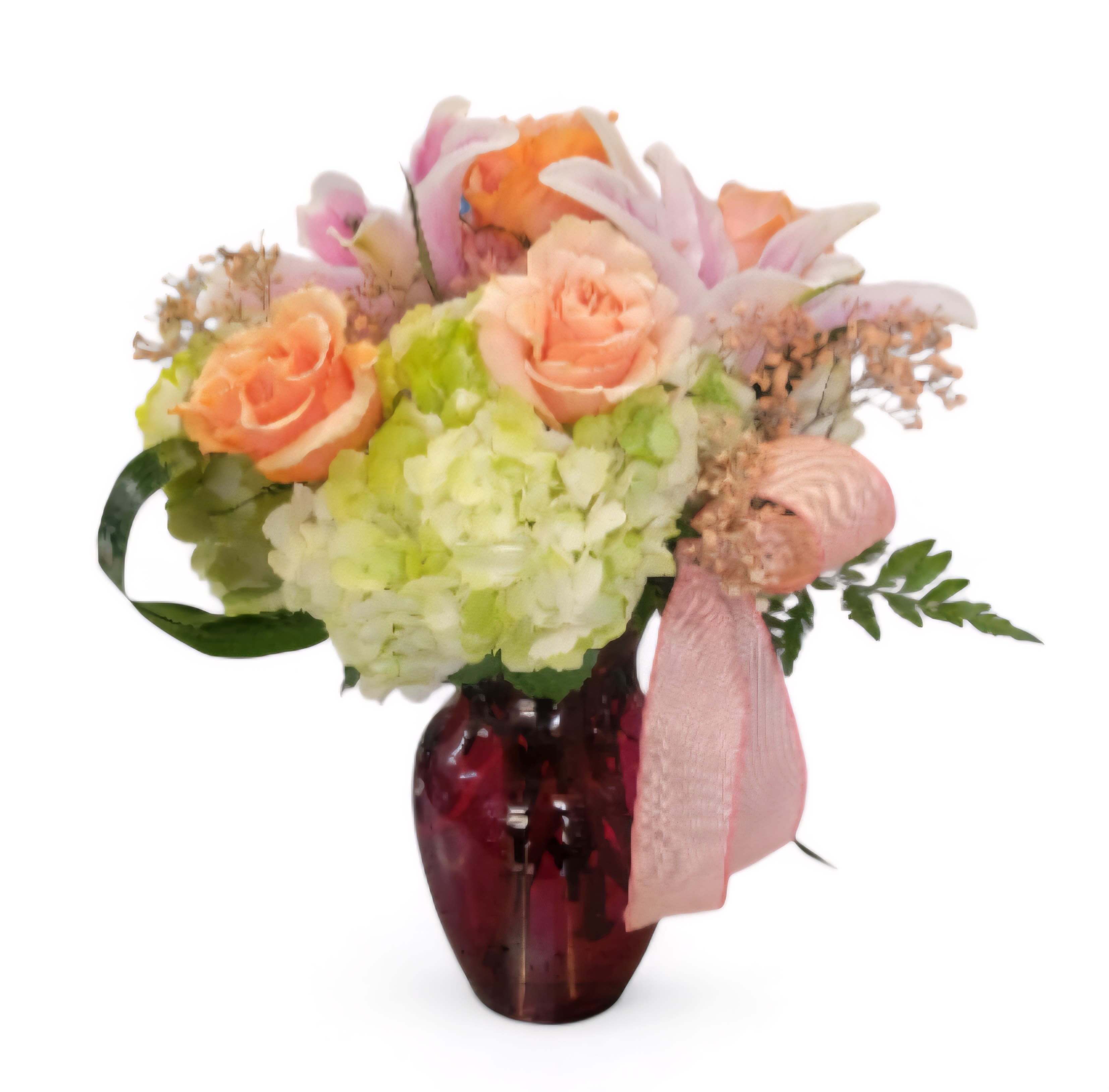Bouquet of peach roses and hydrangeas in a red glass vase with a pink ribbon